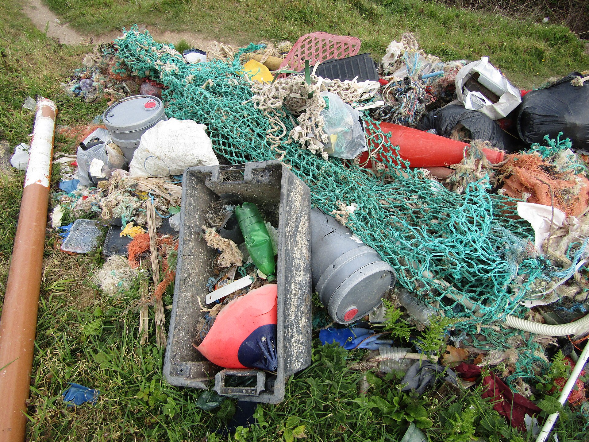 A pile of derelict fishing gear collected from a beach, including tangled net, rope and floats of the kind that becomes ghost gear at sea